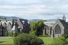Historic stone buildings of Christ College Brecon set in the Welsh countryside